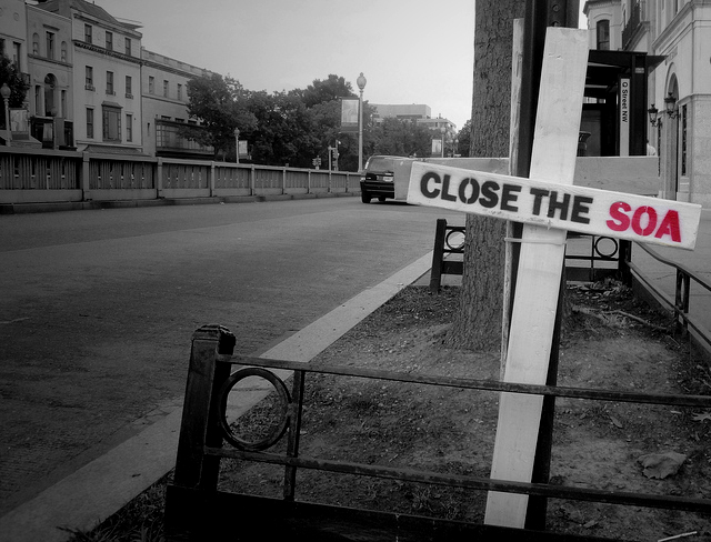 Commentary on the Honduran coup of late June 2009. The installation is two wooden crosses, a style popularized in the movement to close the SOA (School of the Americans/Western Hemisphere Institute for Security Cooperation). (Photo: DC Protests; Edited: LW / TO)